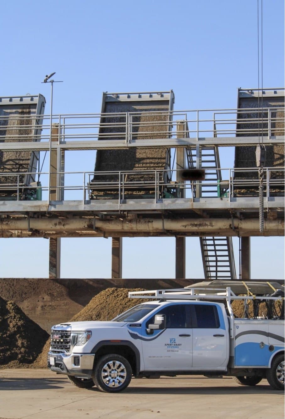 XDS service truck parked beneath a dairy separator platform